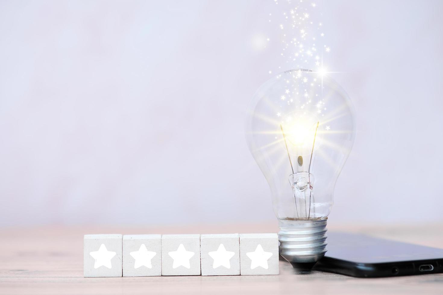 Energy saving light bulb on table and business growth concept and new ideas innovation photo