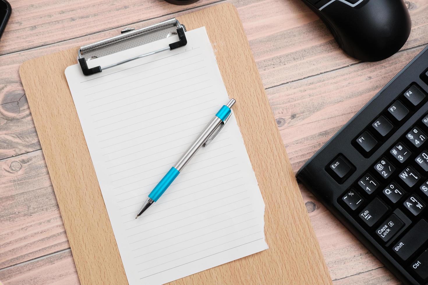 Keyboard on wood table background and top view working space photo