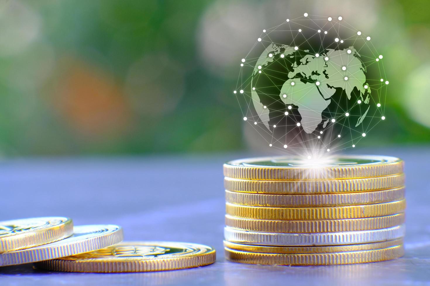 A illustration of a globe on a stack of coins photo