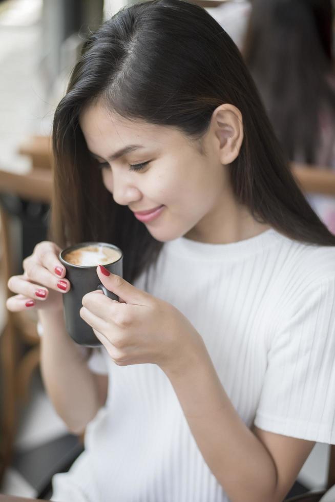 Beautiful business girl working with tablet , smartphone and drinking coffee in coffee shop photo