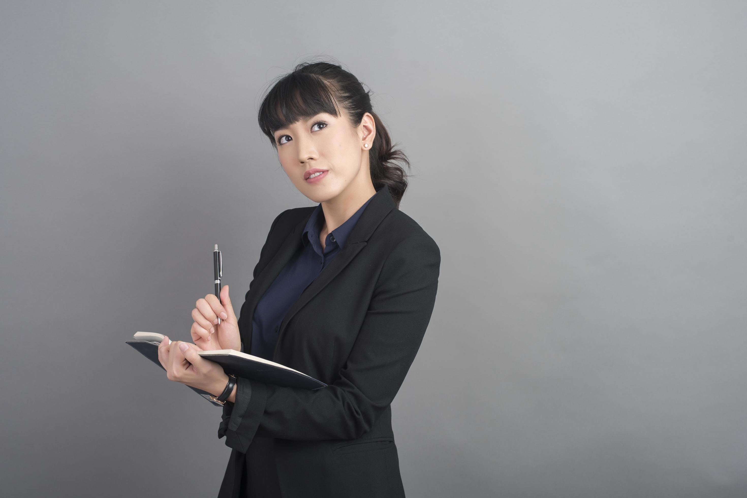 Beautiful Business Woman thinking on grey background 2597950 Stock ...