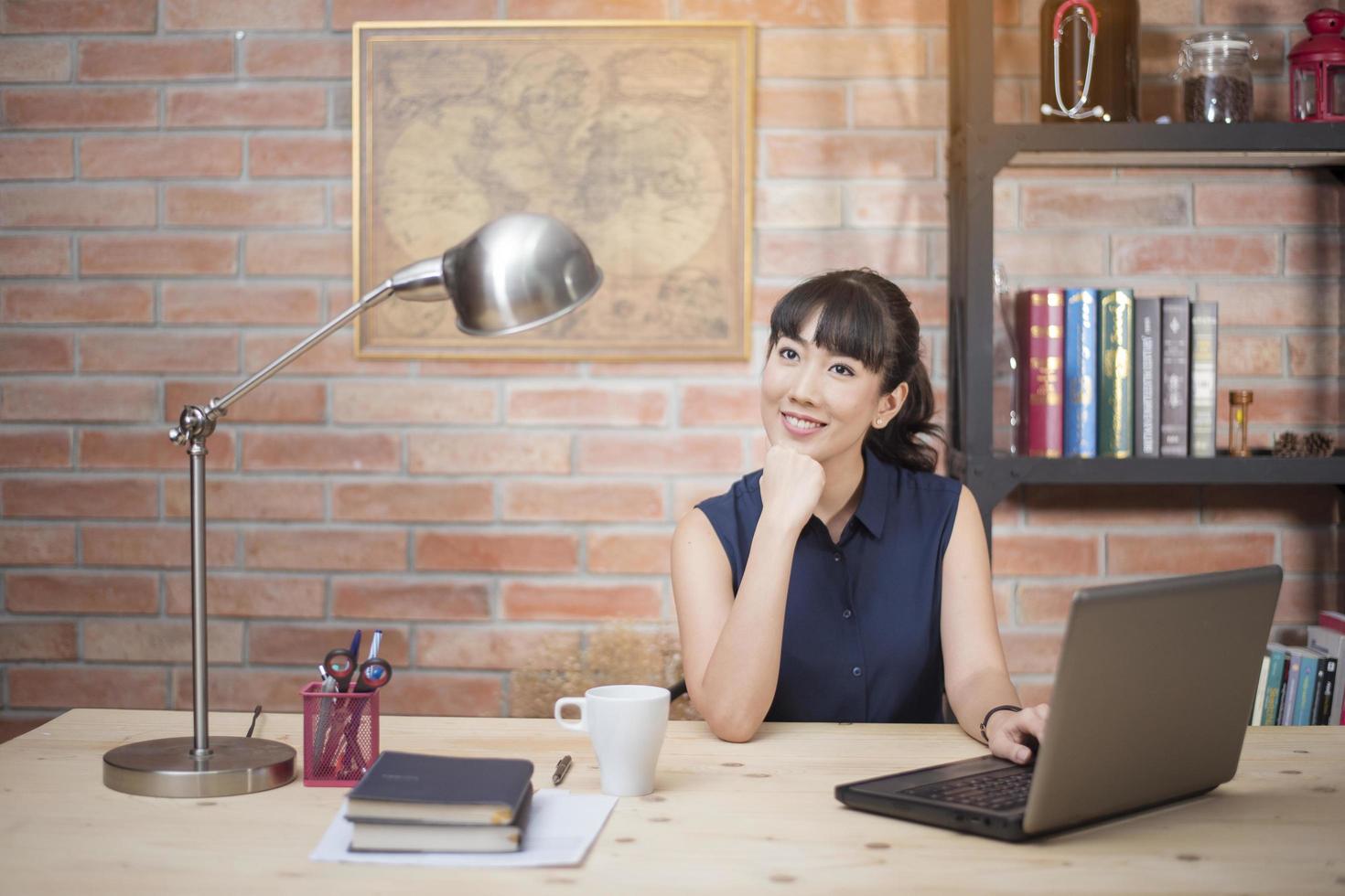 Beautiful woman is working in home office photo