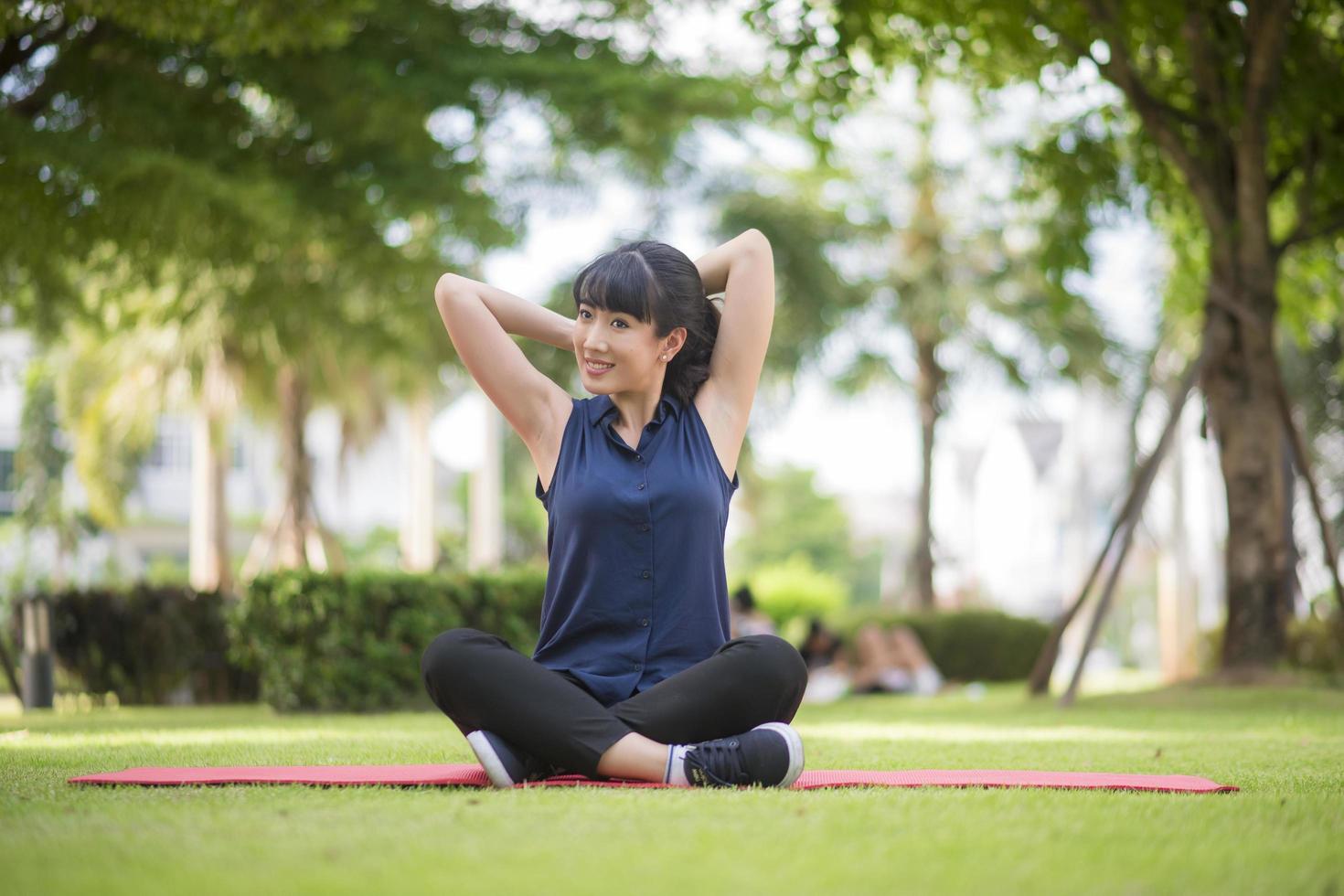 Beautiful yoga woman on green park photo