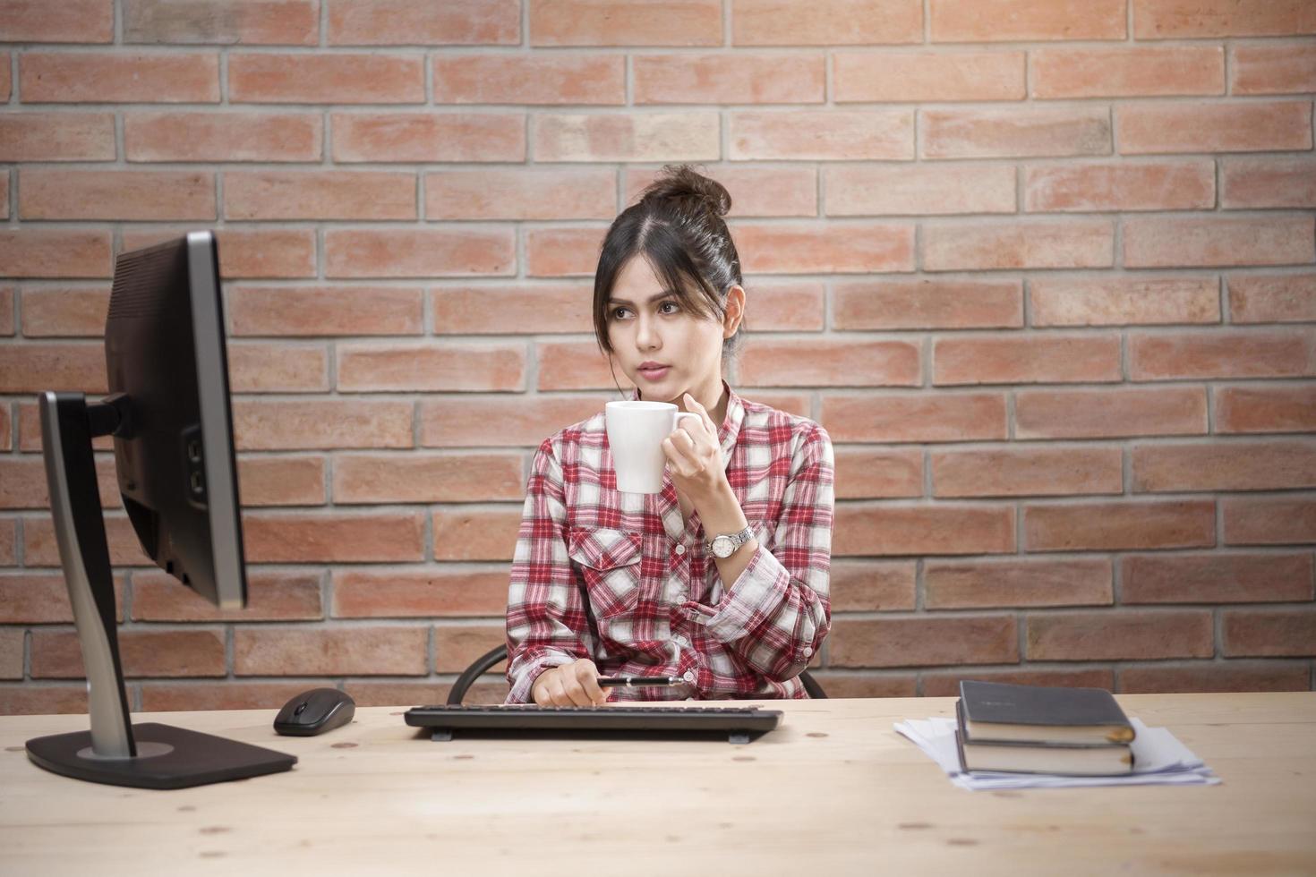 Beautiful woman is working in home office photo