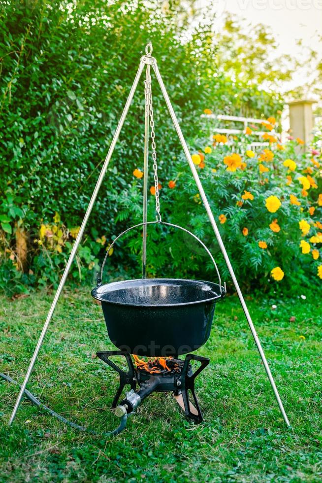 Cooking beef goulash soup in a cauldron photo