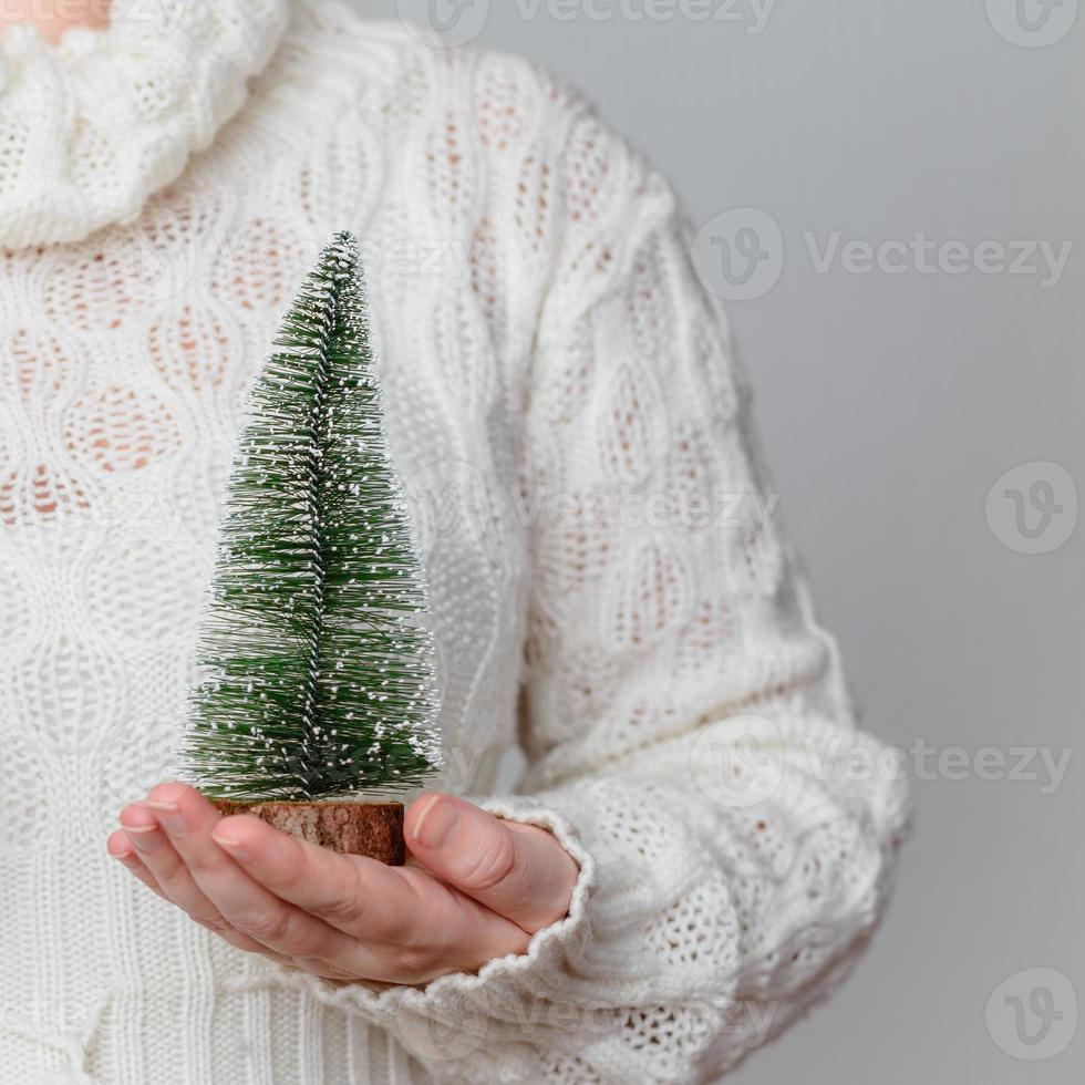 Woman holding a Christmas tree ornament photo