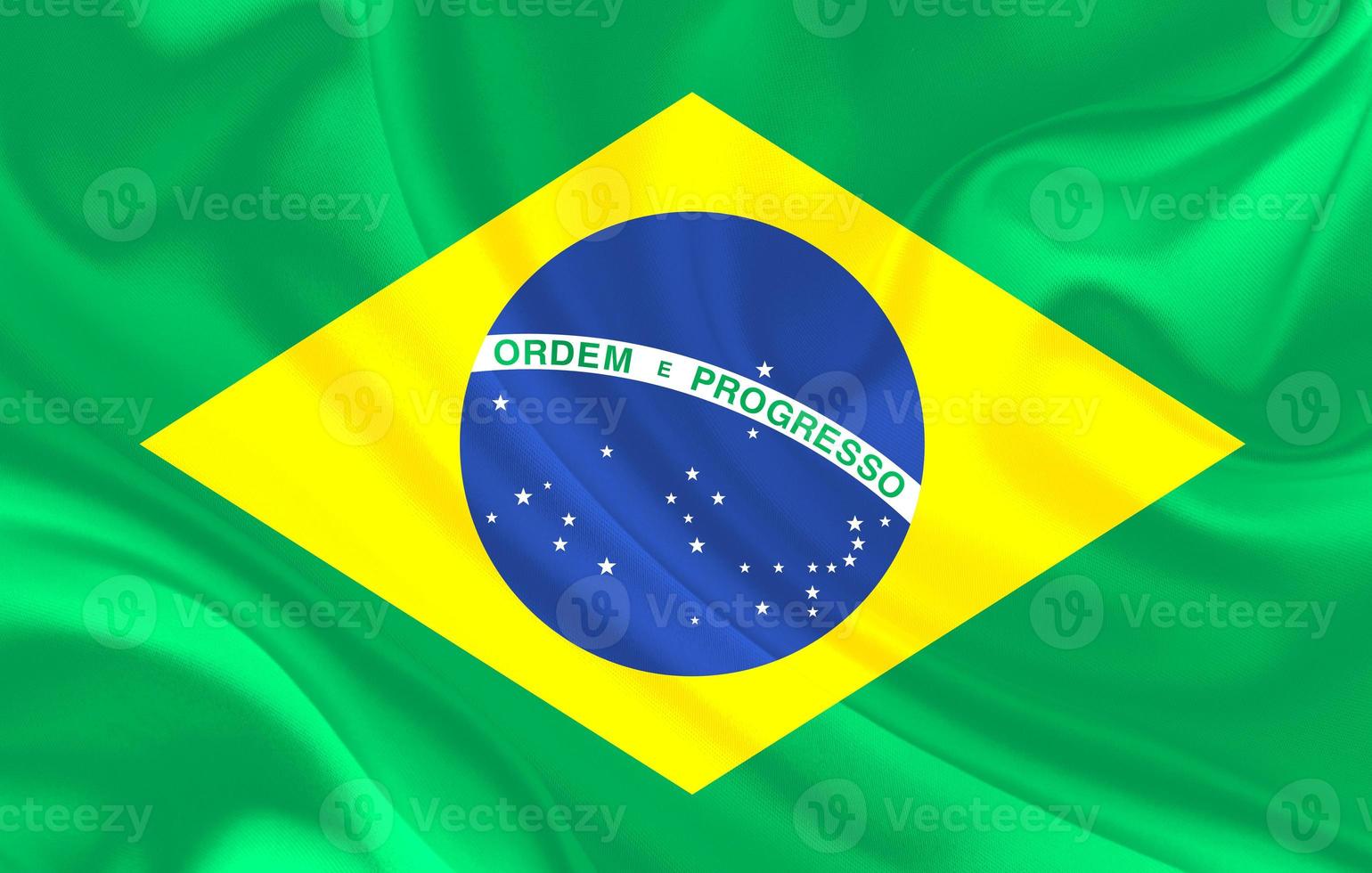 La bandera del país de Brasil sobre fondo de textiles de seda ondulada foto