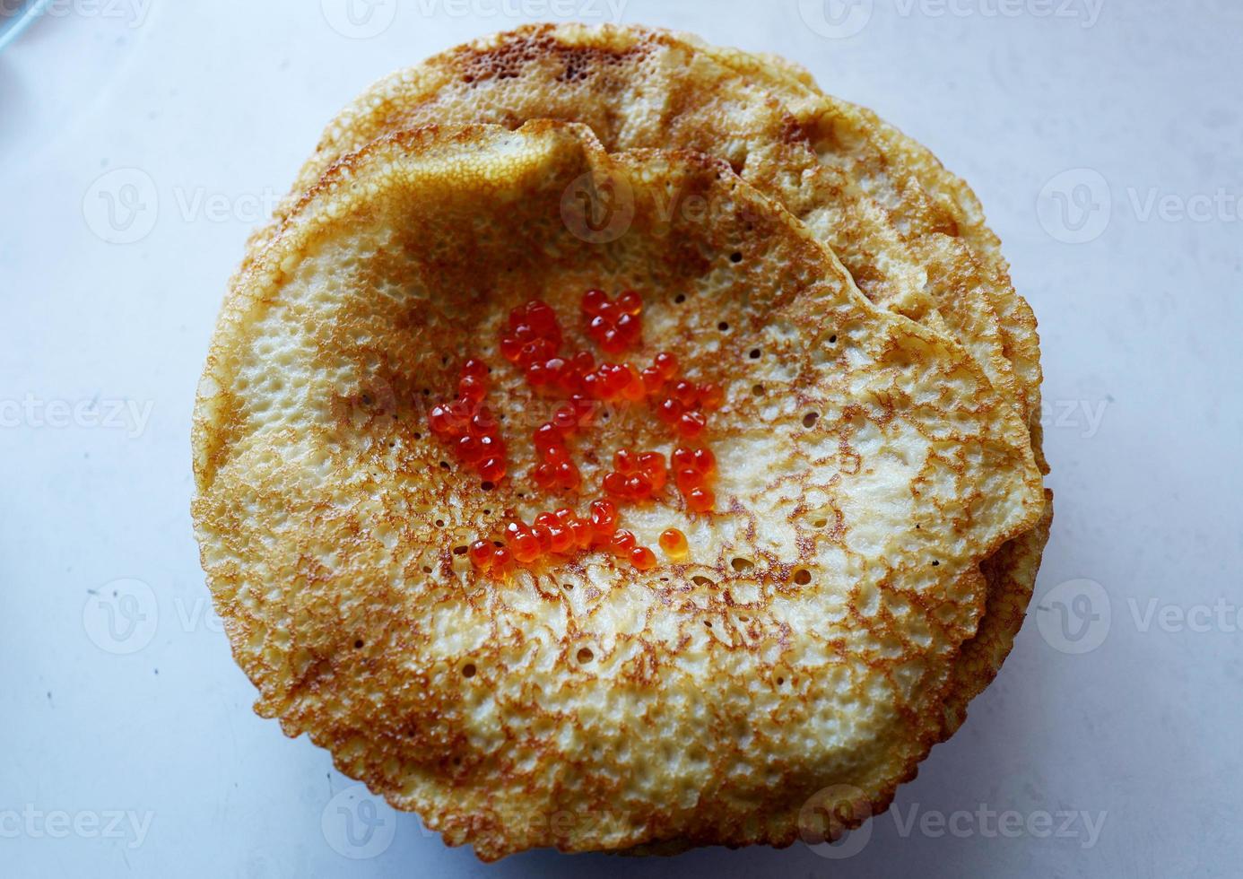 Russian pancakes with red caviar photo