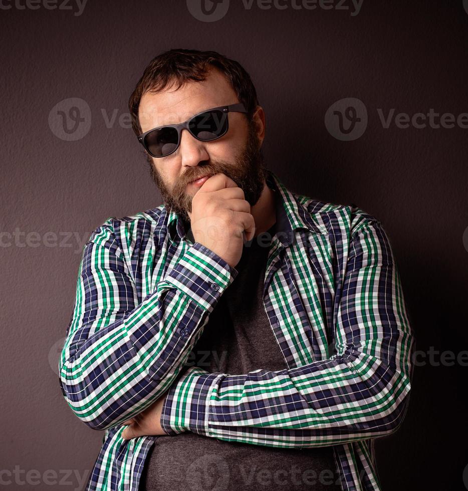 Handsome hipster bearded man with sunglasses and shirt photo