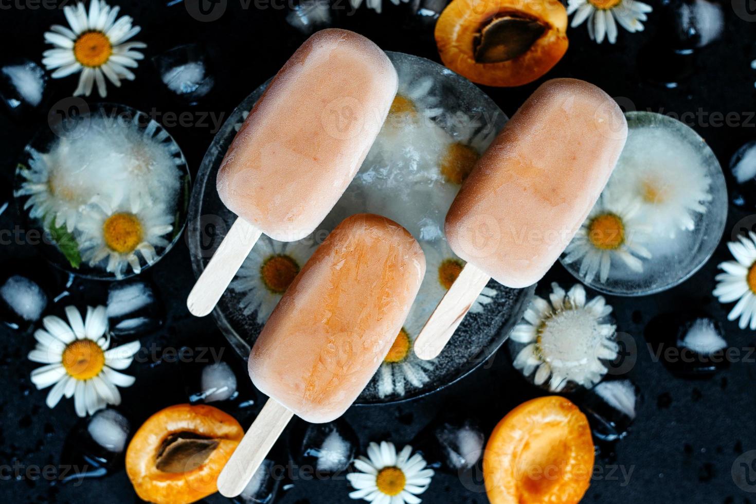 Homemade ice cream on a stick of apricots and yogurt. Healthy eating concept photo