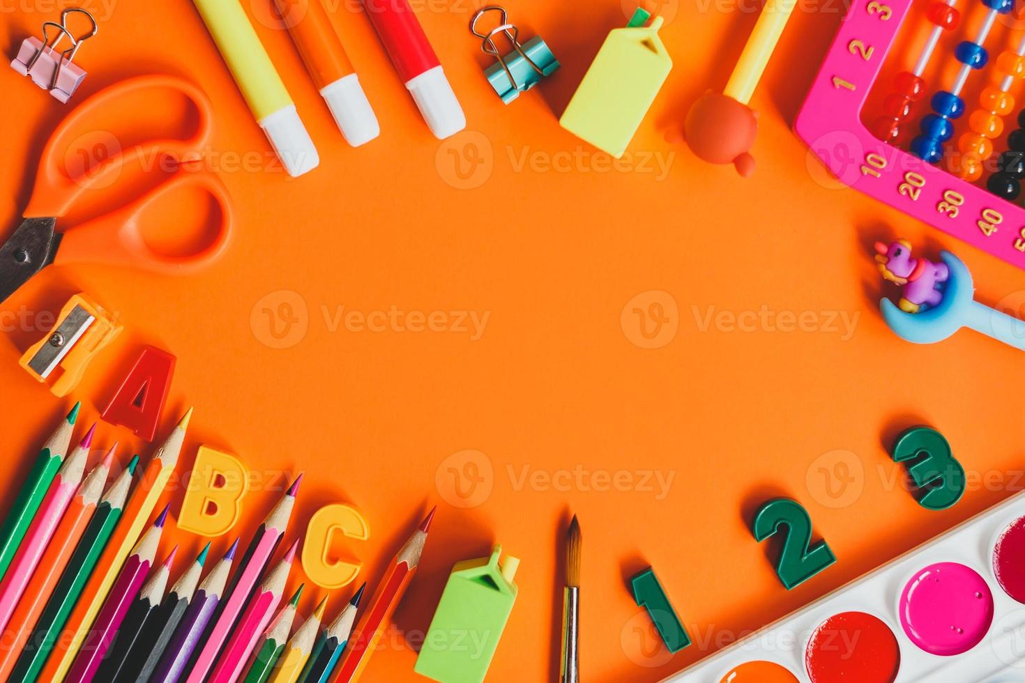 Back to school. School supplies on orange background. Top view. Copy space. photo