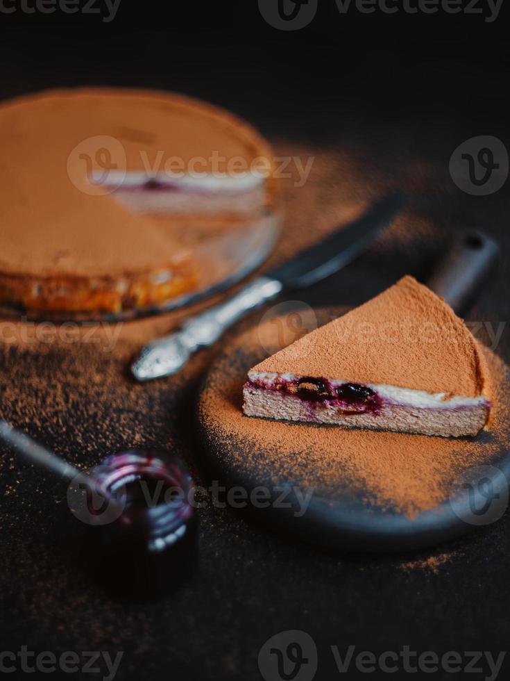 Appetizing cottage cheese casserole or cheesecake with cocoa and jam photo