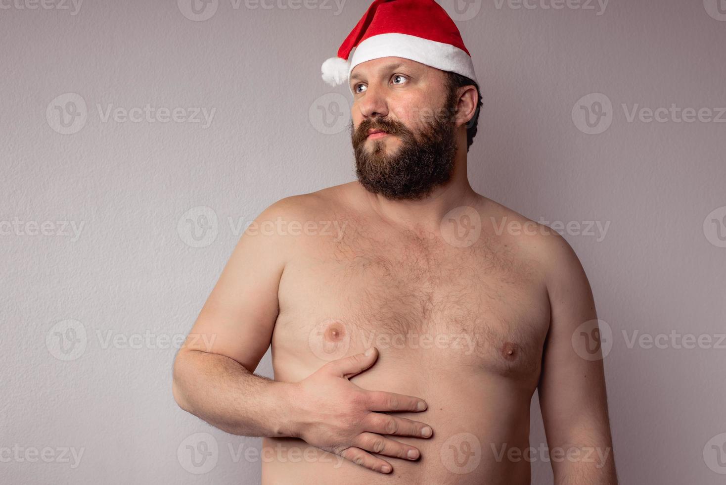 Bearded half-naked Santa Claus man photo