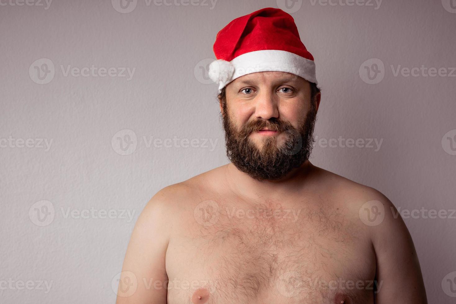 Bearded half-naked Santa Claus photo