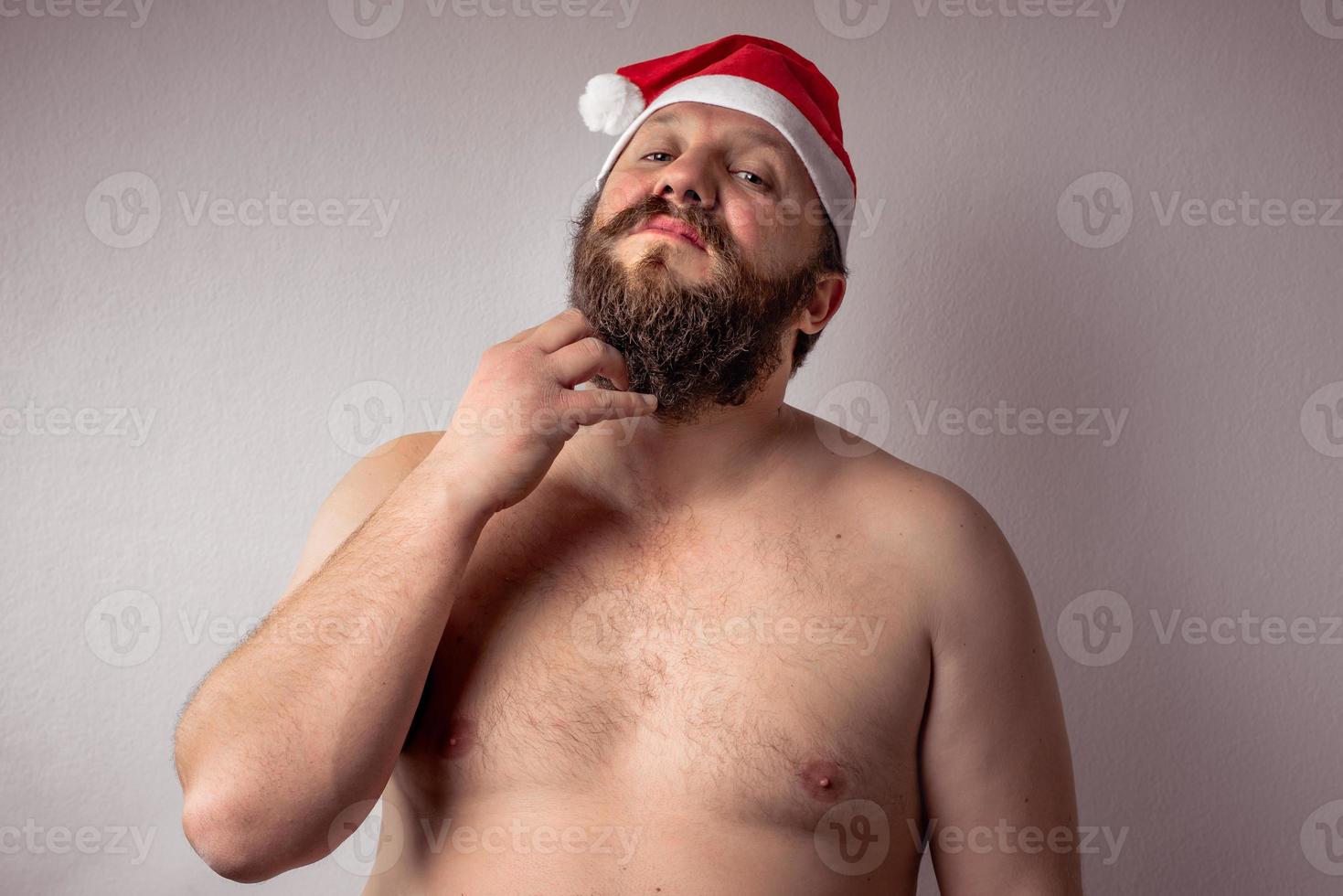 Bearded half-naked Santa Claus man photo
