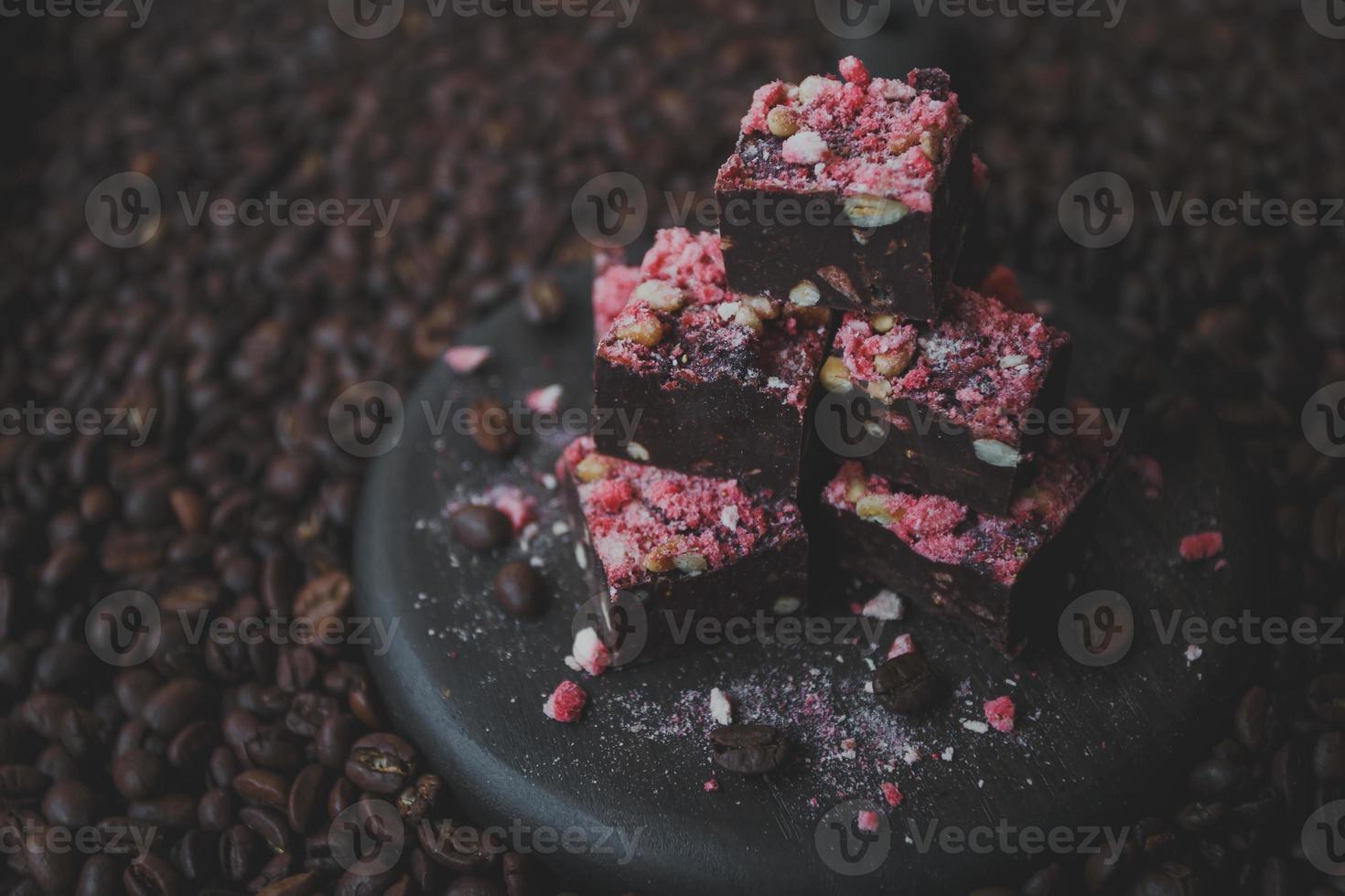 Homemade chocolate fudge with strawberries and pine nuts photo