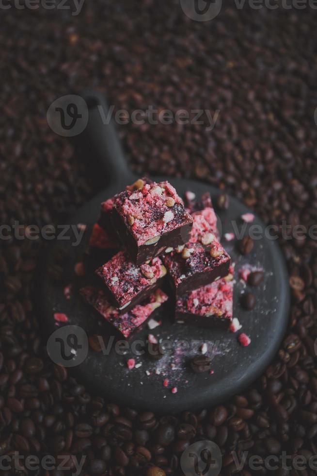 Homemade chocolate fudge with strawberries and pine nuts photo