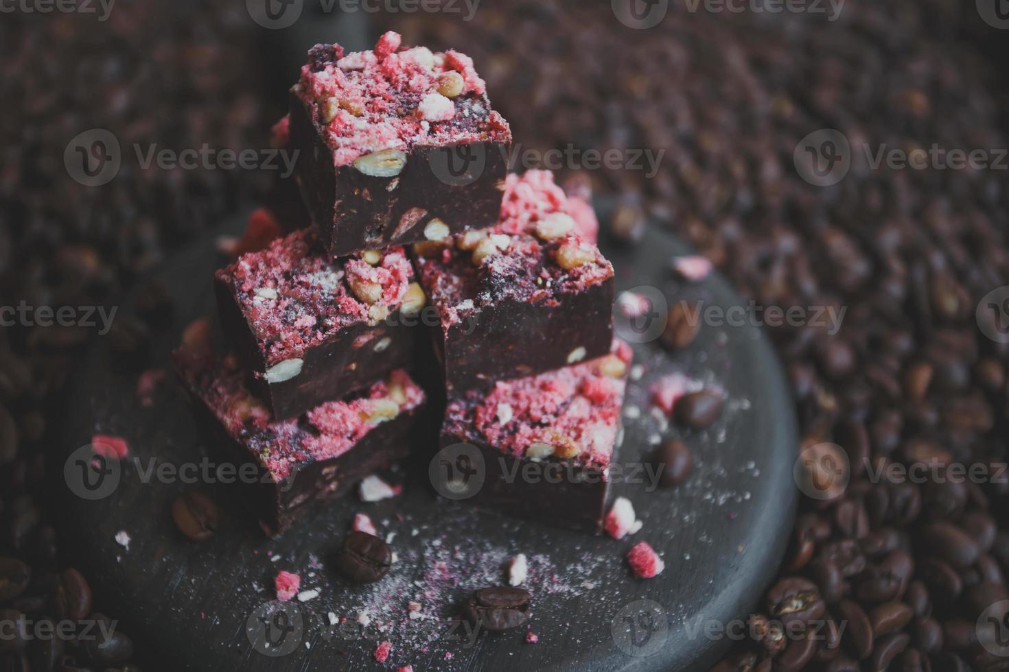 Homemade chocolate fudge with strawberries and pine nuts photo