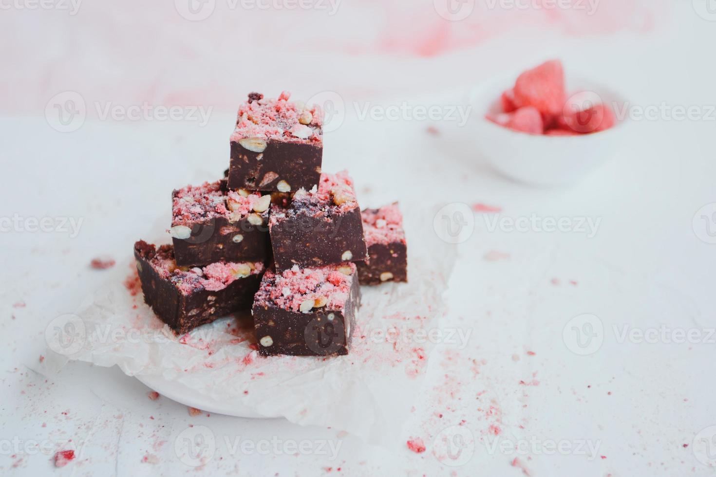 Homemade chocolate fudge with strawberries and pine nuts photo