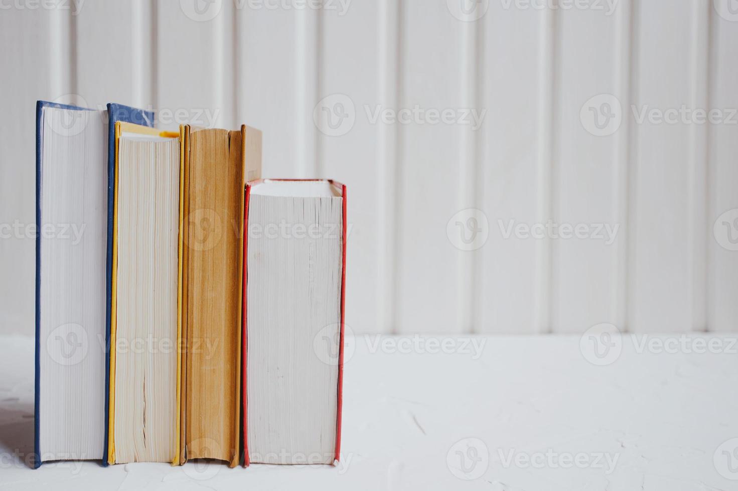 Stacks of educational books on a white background. Education concept. photo