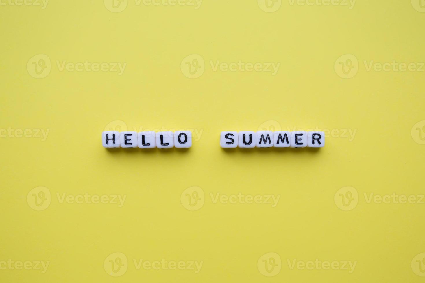 Hello summer word cubes, on a yellow background. photo