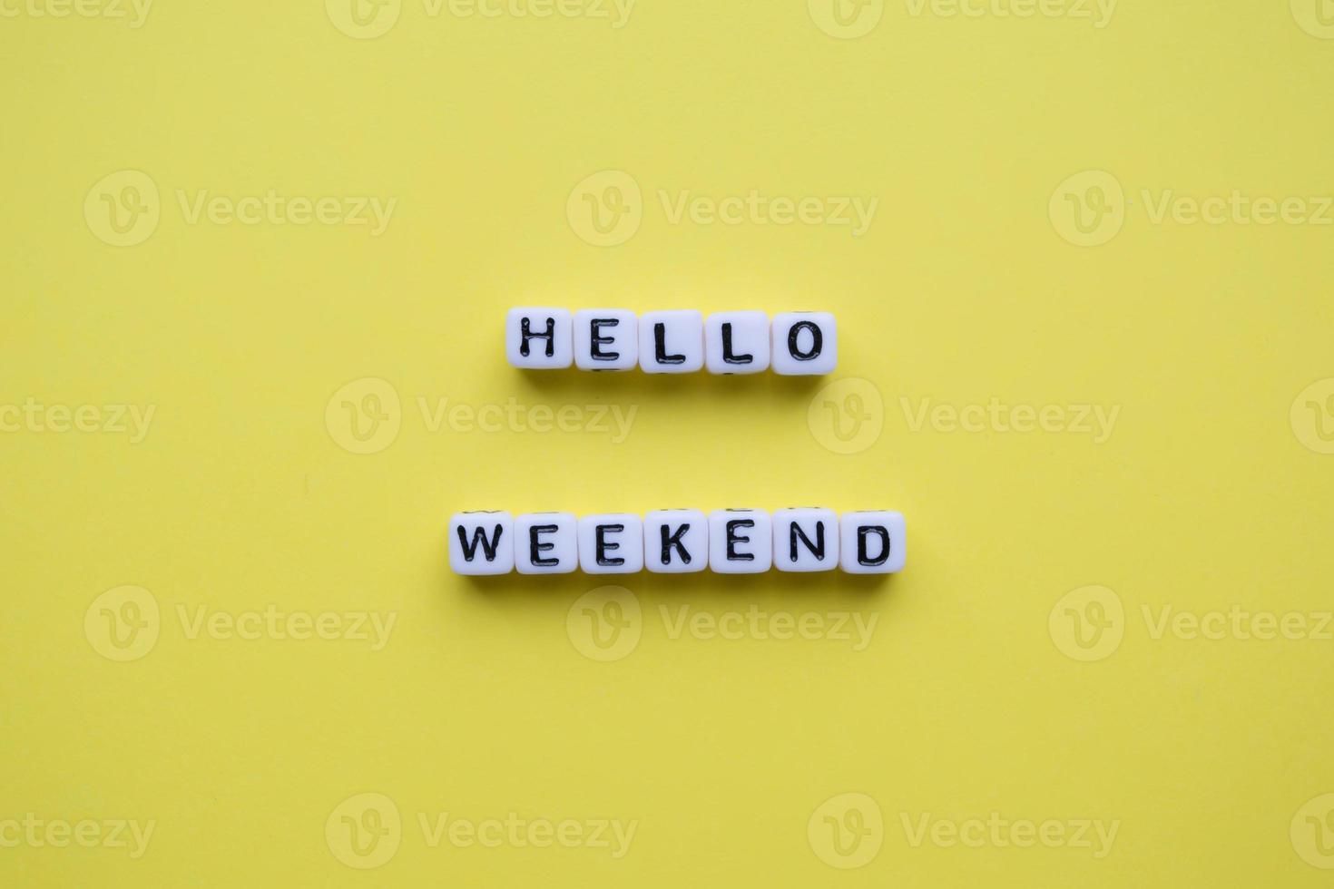 Hello weekend words on yellow background. photo