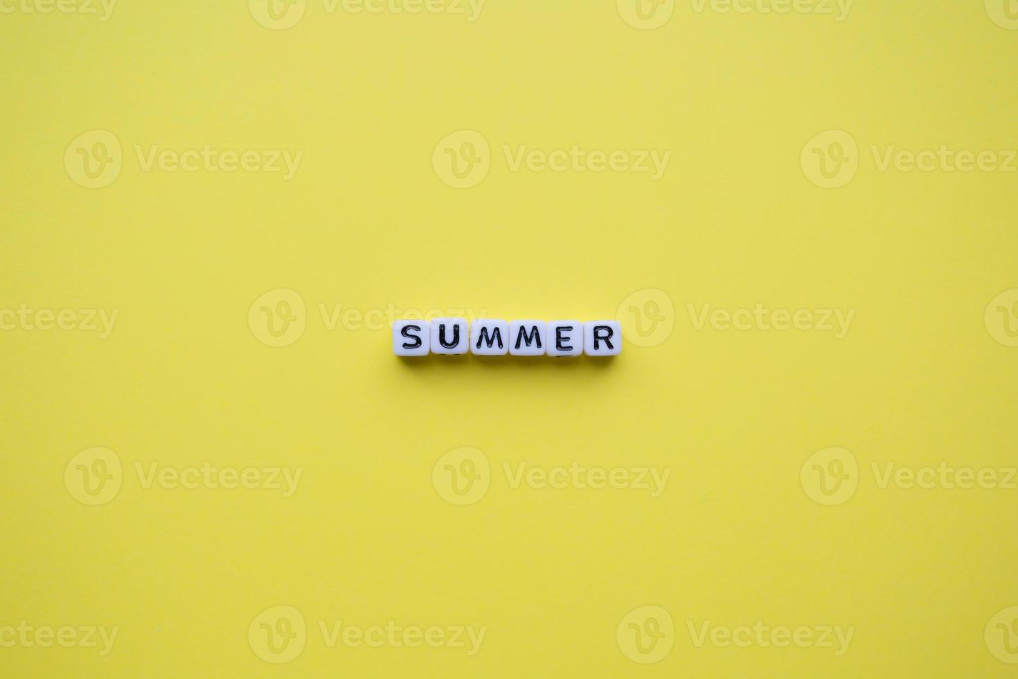 Summer word cubes, on a yellow background. photo