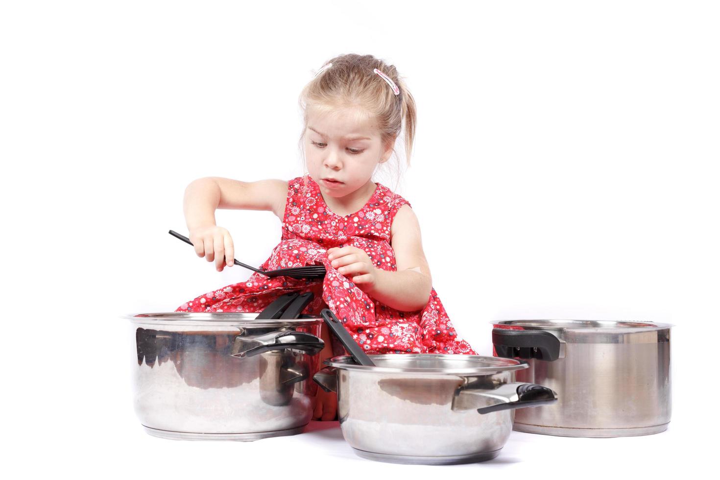 Little child using cuisine accessories having fun photo