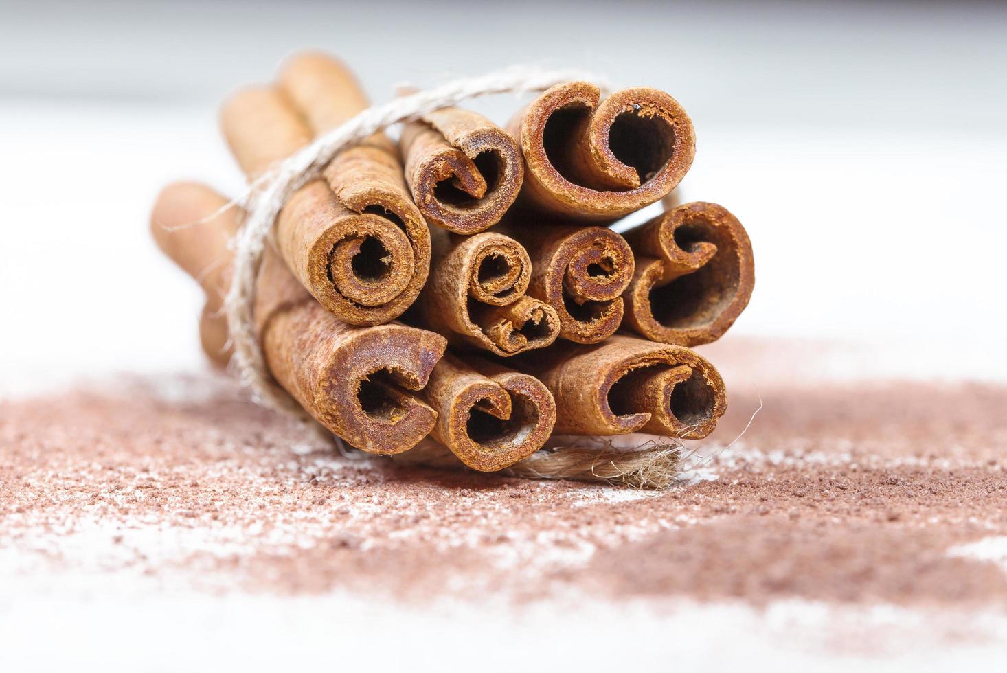 Cinnamon sticks and cocoa powder accessories for a cozy winter evening near the fireplace with a glass of wine photo