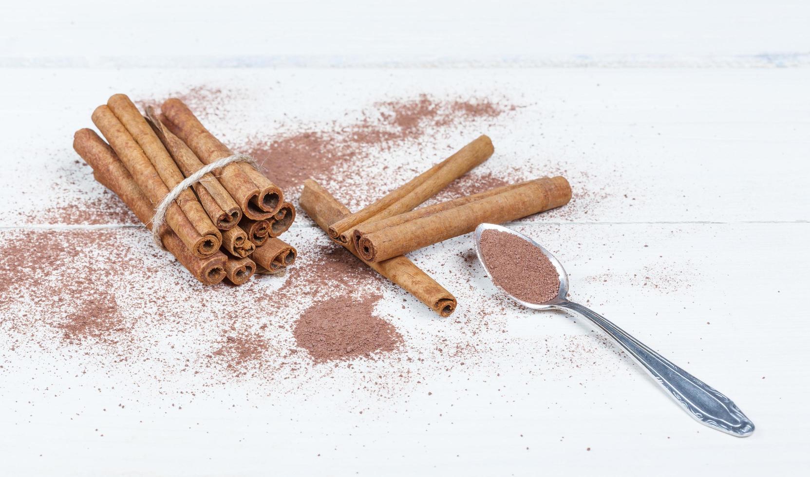 Cinnamon sticks and cocoa powder accessories for a cozy winter evening near the fireplace with a glass of wine photo