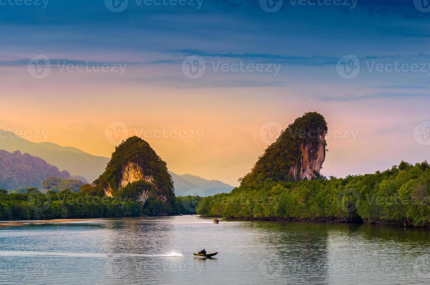 Khao kha nab nam at Krabi Thailand. The famous tourist attraction in southern of thailand. Twin mountains have rivers through the middle of the evening atmosphere with golden light. photo