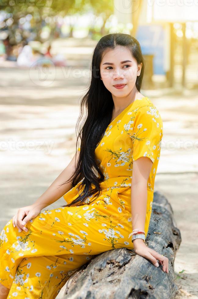 Lovely Asian girl with white skin sitting on sand photo