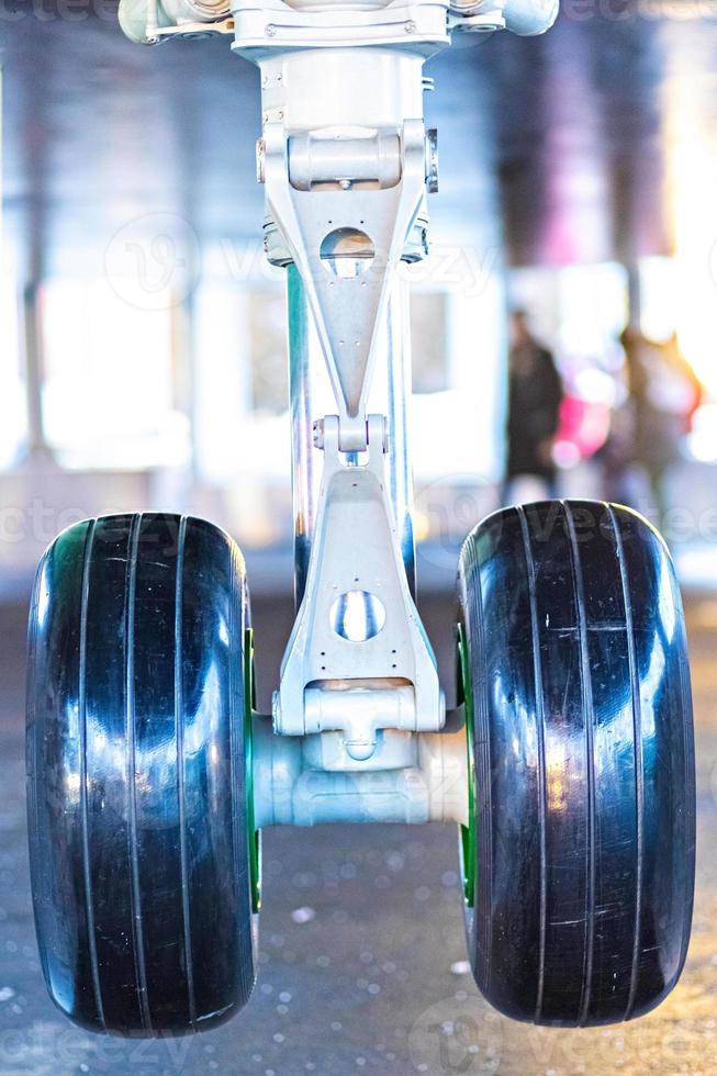 The forward landing gear of a passenger aircraft in the air when landing at the airport. photo