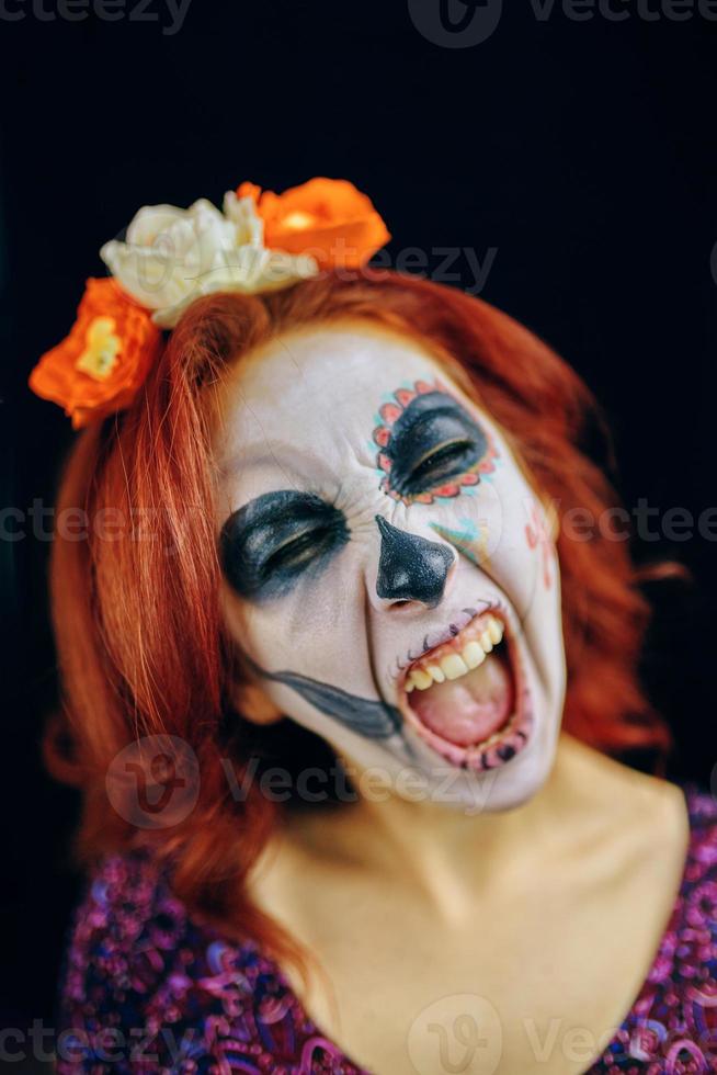 Young woman in day of the dead mask skull face art. photo