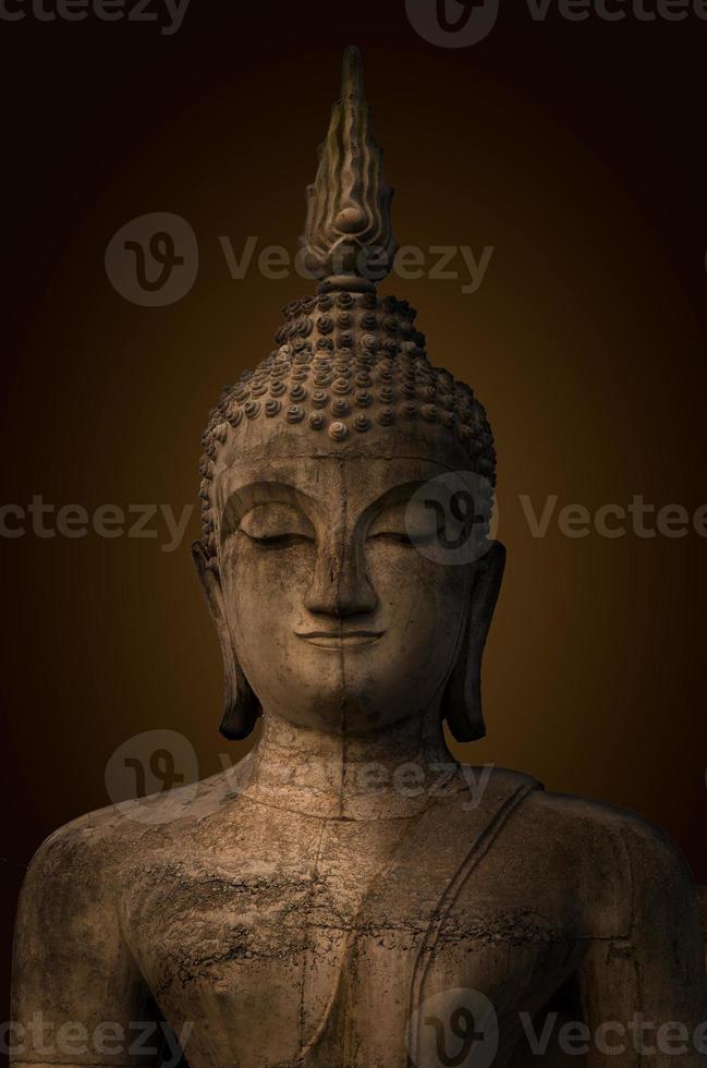 Buddha statue used as amulets of Buddhism religion.The ancient Buddha, dark brown background. photo