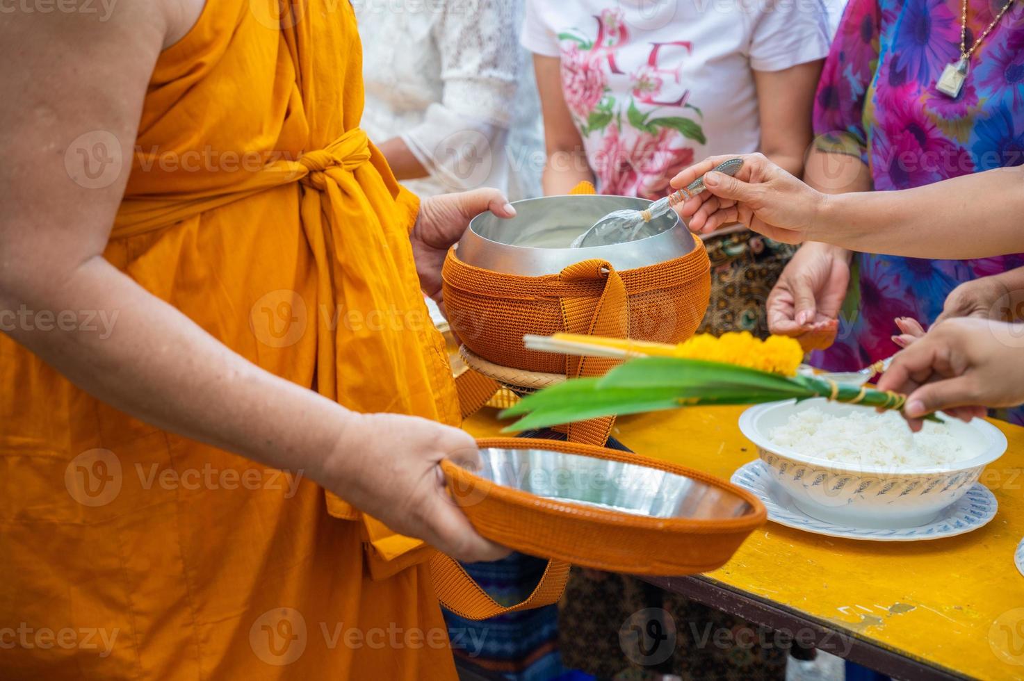 Alms round The yellow robes of monks walk on alms round as a Buddhist activity. photo