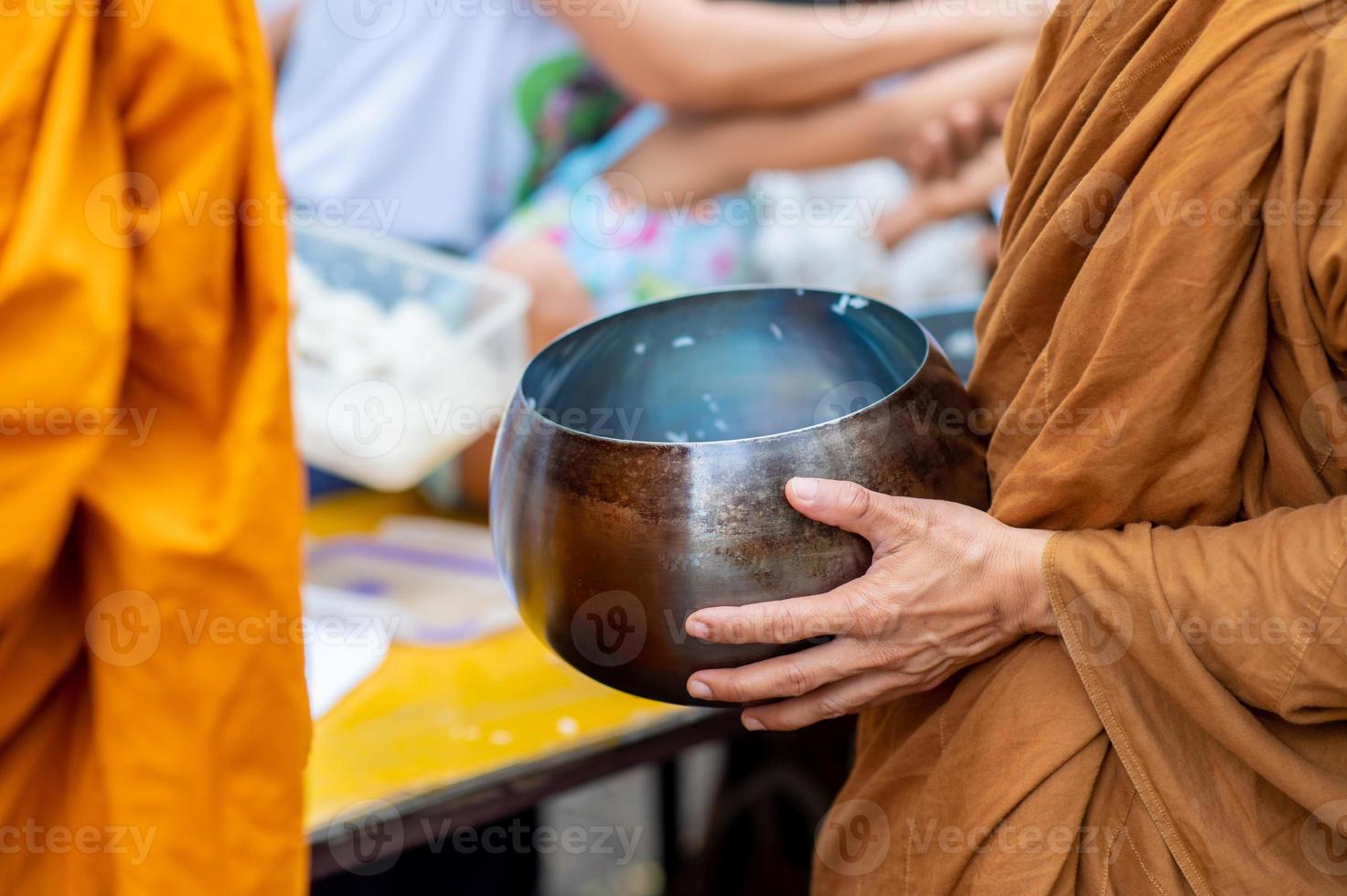 Alms round The yellow robes of monks walk on alms round as a Buddhist activity. photo