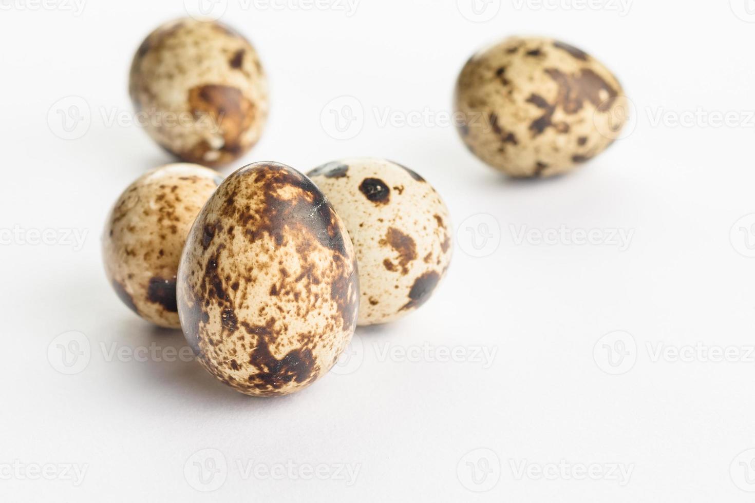 Quail eggs on white background. Organic product. photo