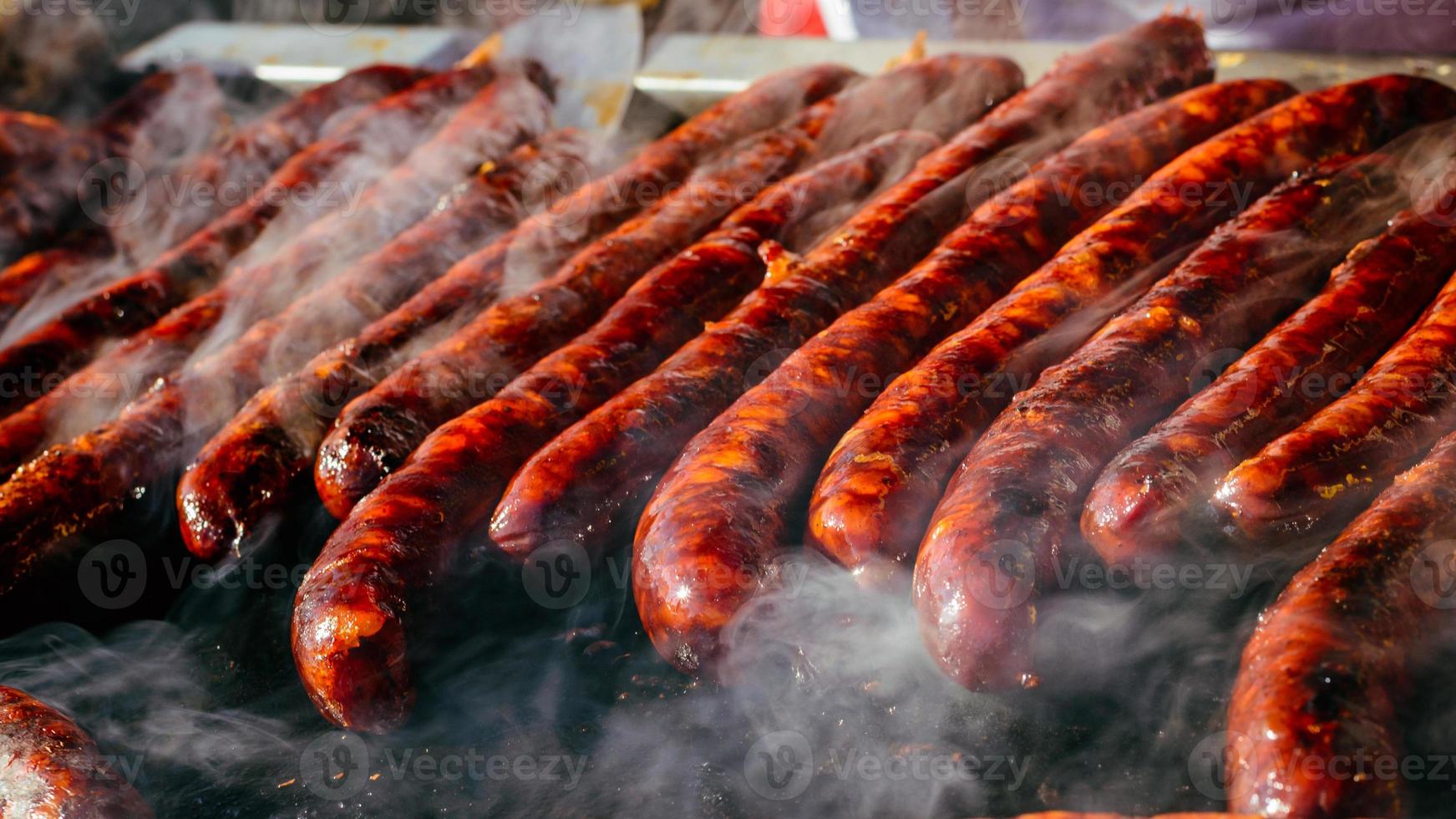 Grilled sausage on barbecue, grill. Shallow depth of field. photo
