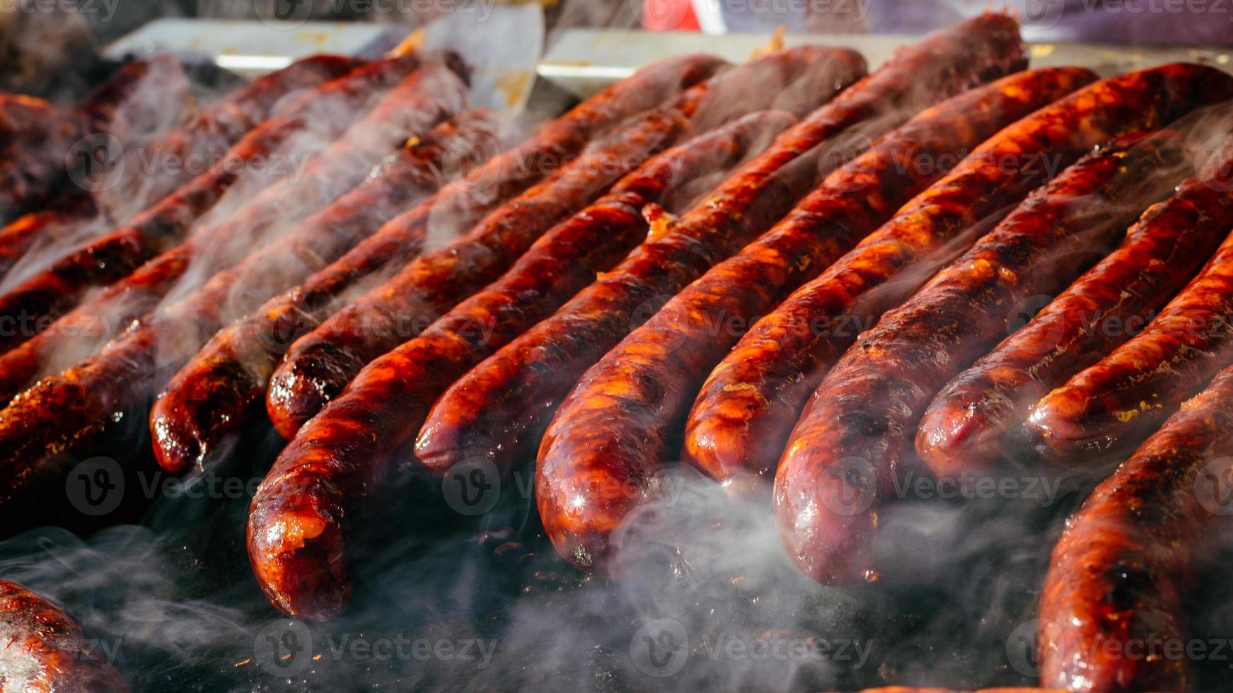 Chorizo a la brasa sobre quincho, grill. poca profundidad de campo. foto