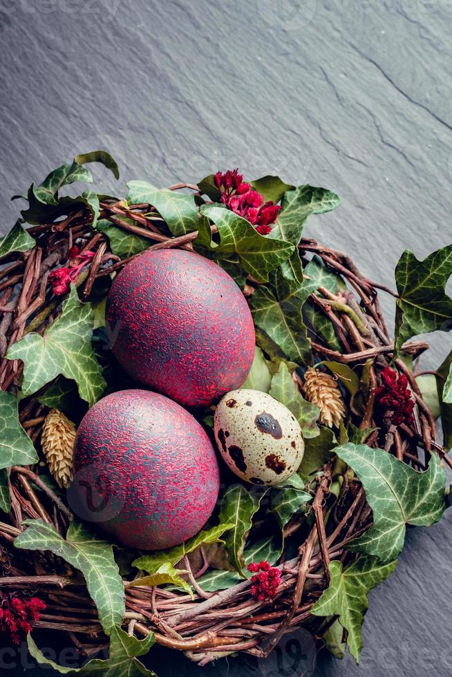 Easter eggs with decoration.Quail and chicken eggs in a birds nest. photo