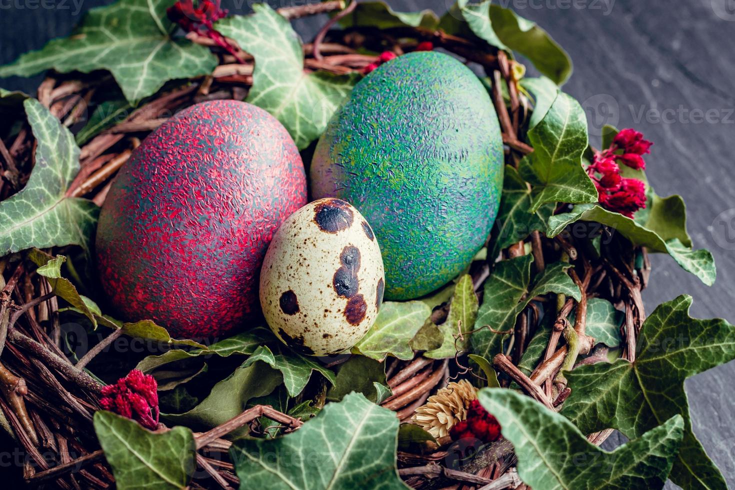 Easter eggs with decoration.Quail and chicken eggs in a birds nest. photo