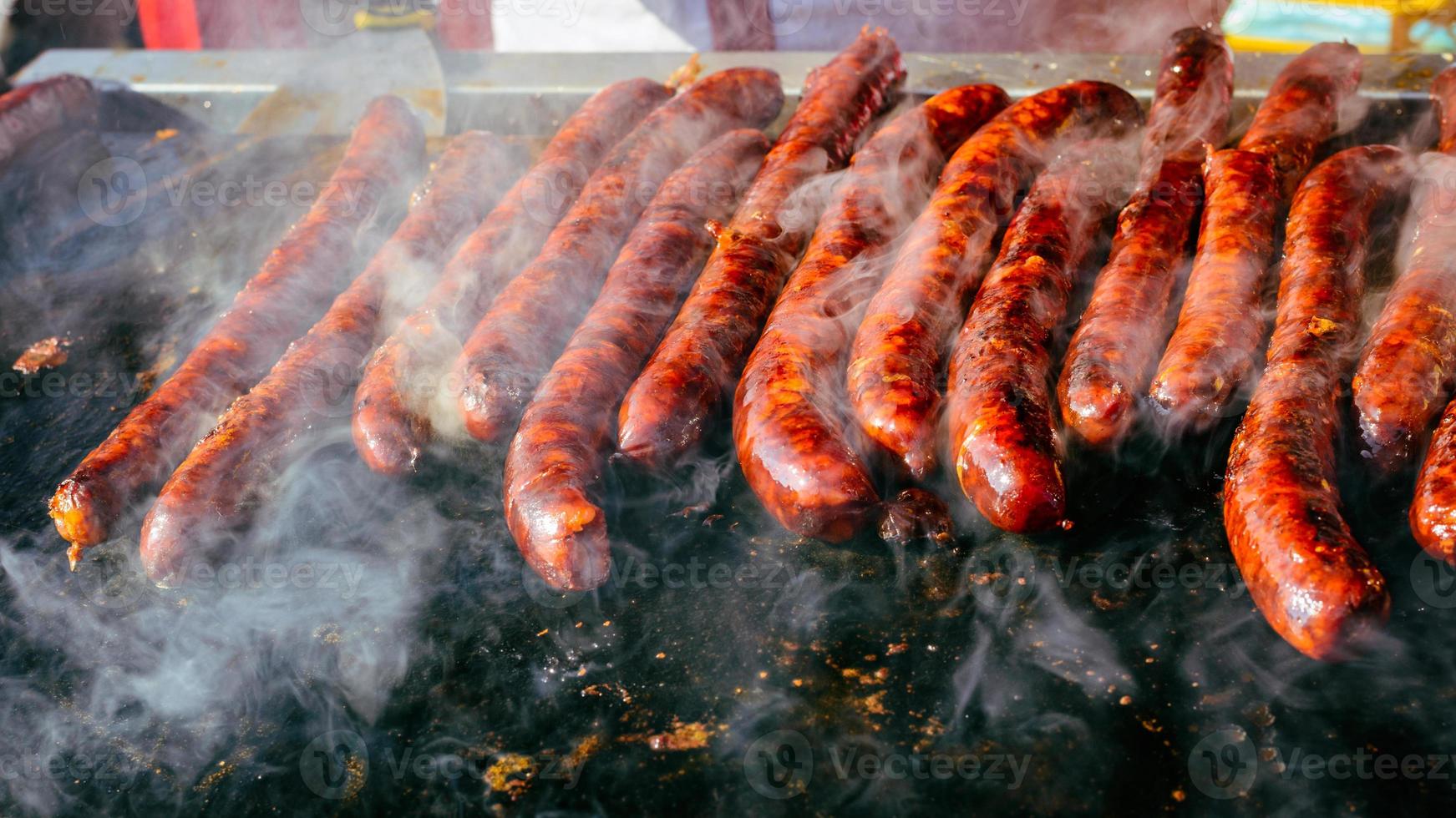 Grilled sausage on barbecue, grill. Shallow depth of field. photo