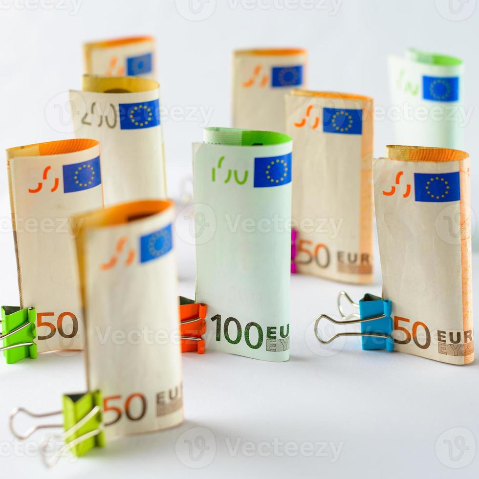 Several hundred euro banknotes. Euro banknotes random stacked. Euro currency money. Banknotes stacked on each other in different positions. photo