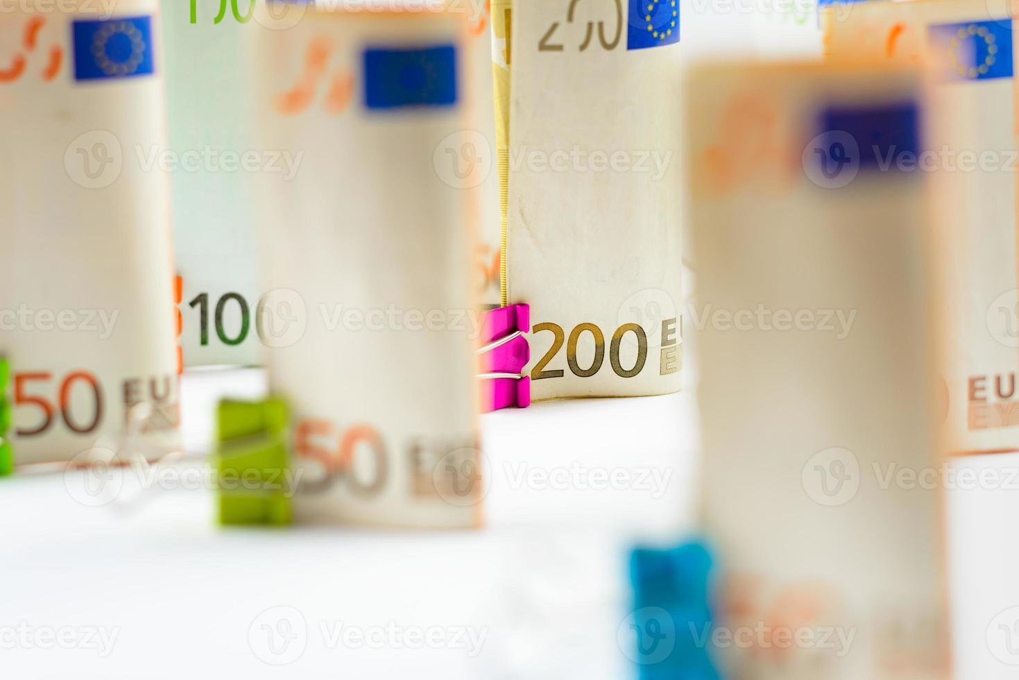 Several hundred euro banknotes. Euro banknotes random stacked. Euro currency money. Banknotes stacked on each other in different positions. photo