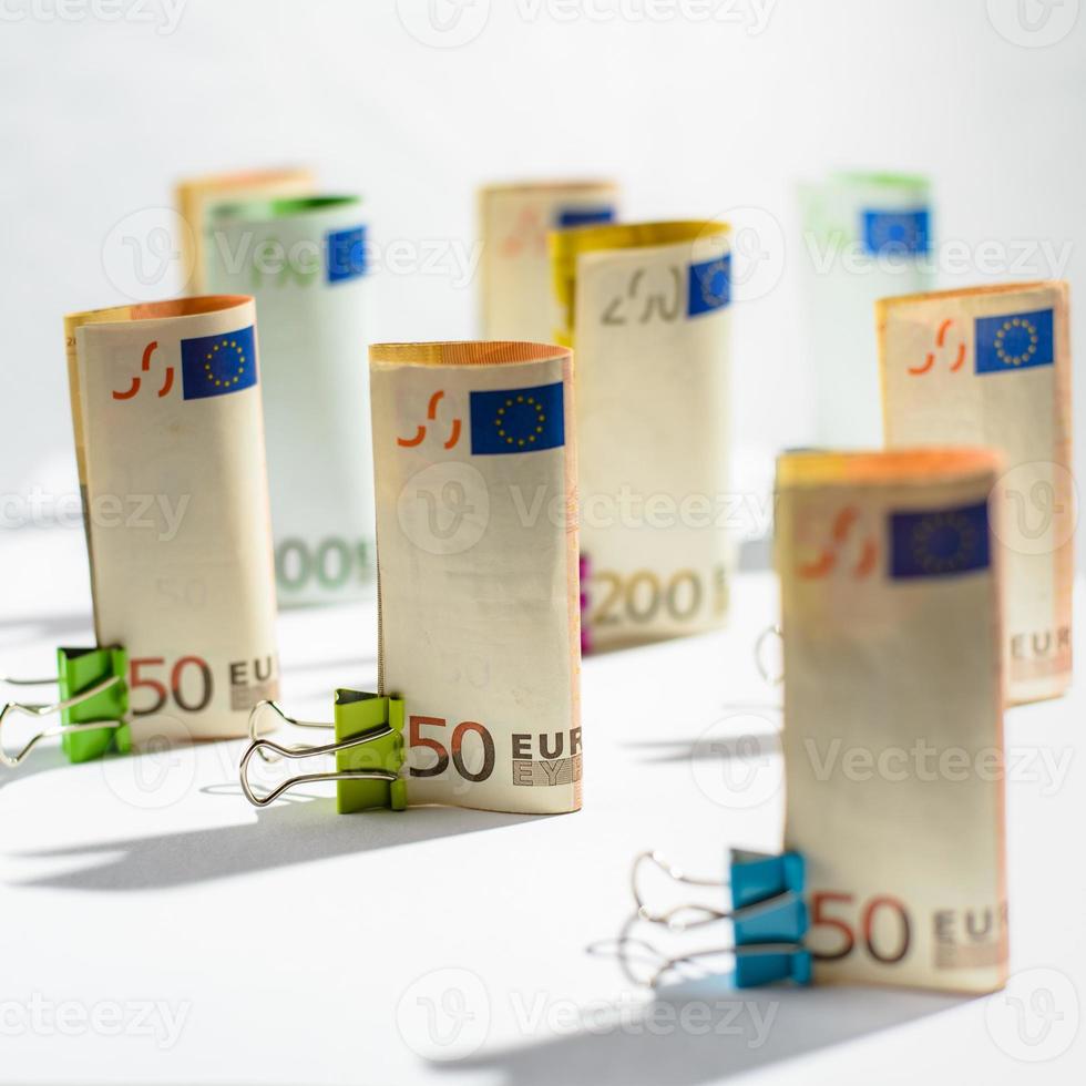 Several hundred euro banknotes. Euro banknotes random stacked. Euro currency money. Banknotes stacked on each other in different positions. photo