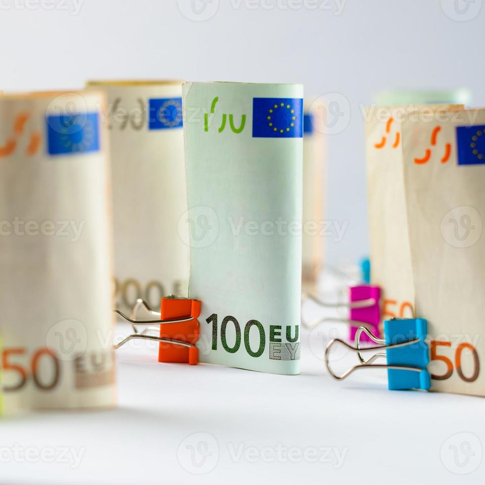 Several hundred euro banknotes. Euro banknotes random stacked. Euro currency money. Banknotes stacked on each other in different positions. photo