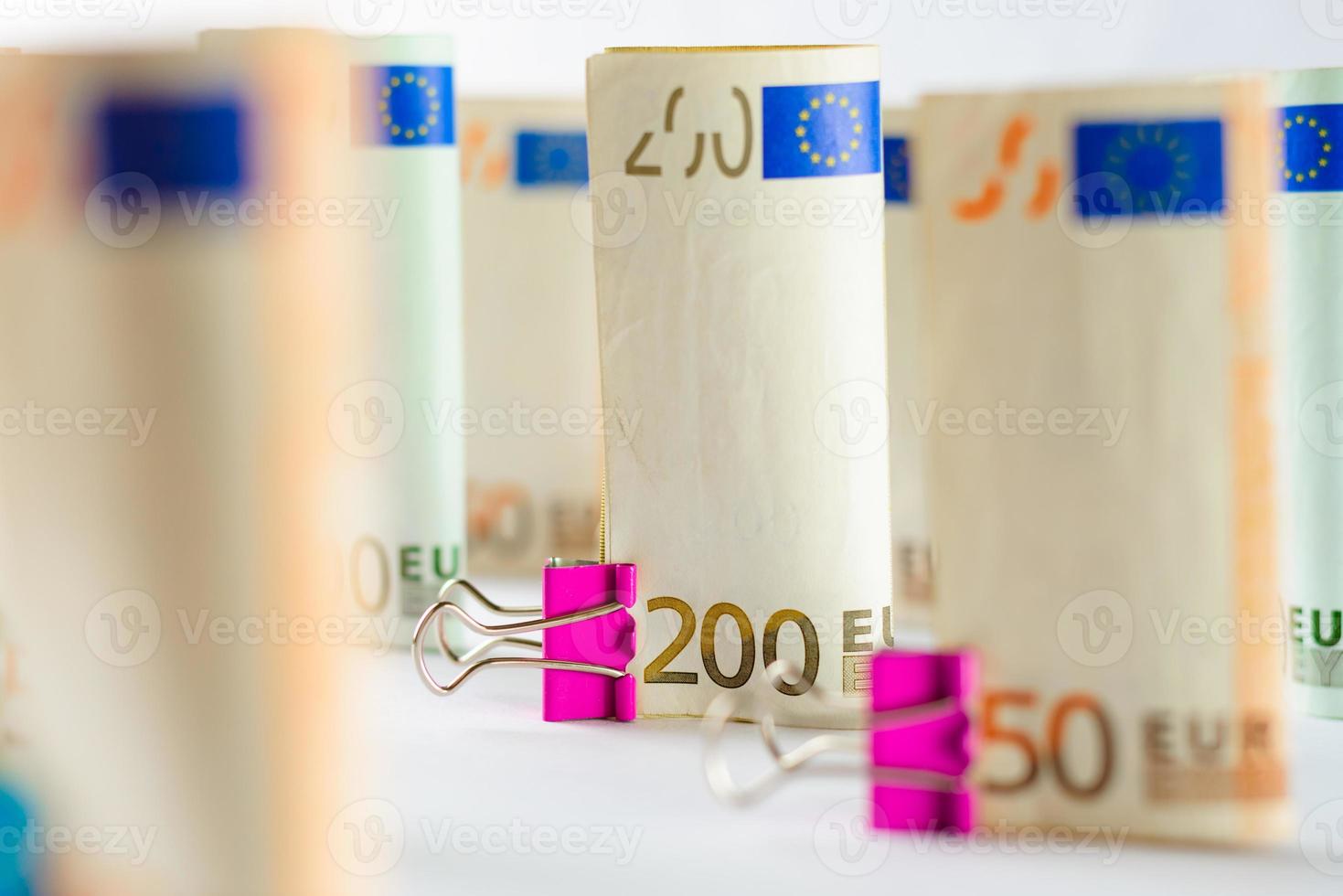 Several hundred euro banknotes. Euro banknotes random stacked. Euro currency money. Banknotes stacked on each other in different positions. photo