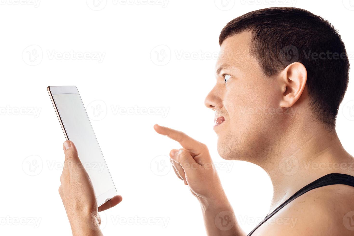 Angry frustrated man using a tablet. Human emotion, reaction, expression. Isolated on white background. photo