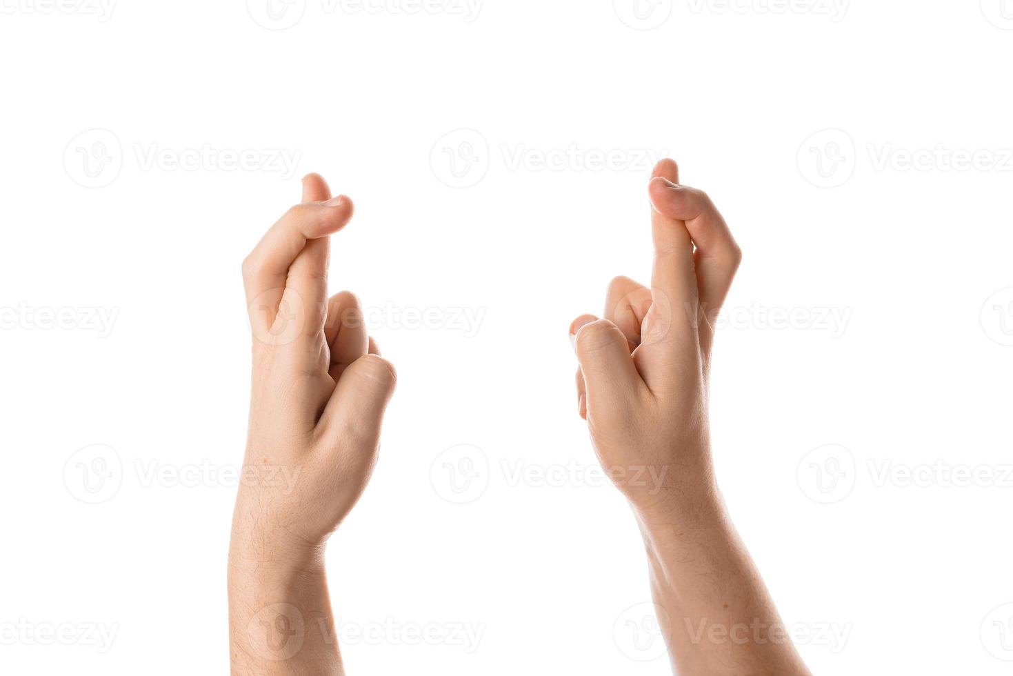 Man keep fingers crossed, hand gesture. Isolated on white background. photo